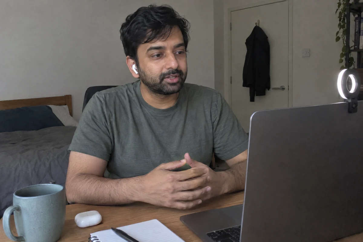 Software developer taking a video interview with two interviewers from his home office
